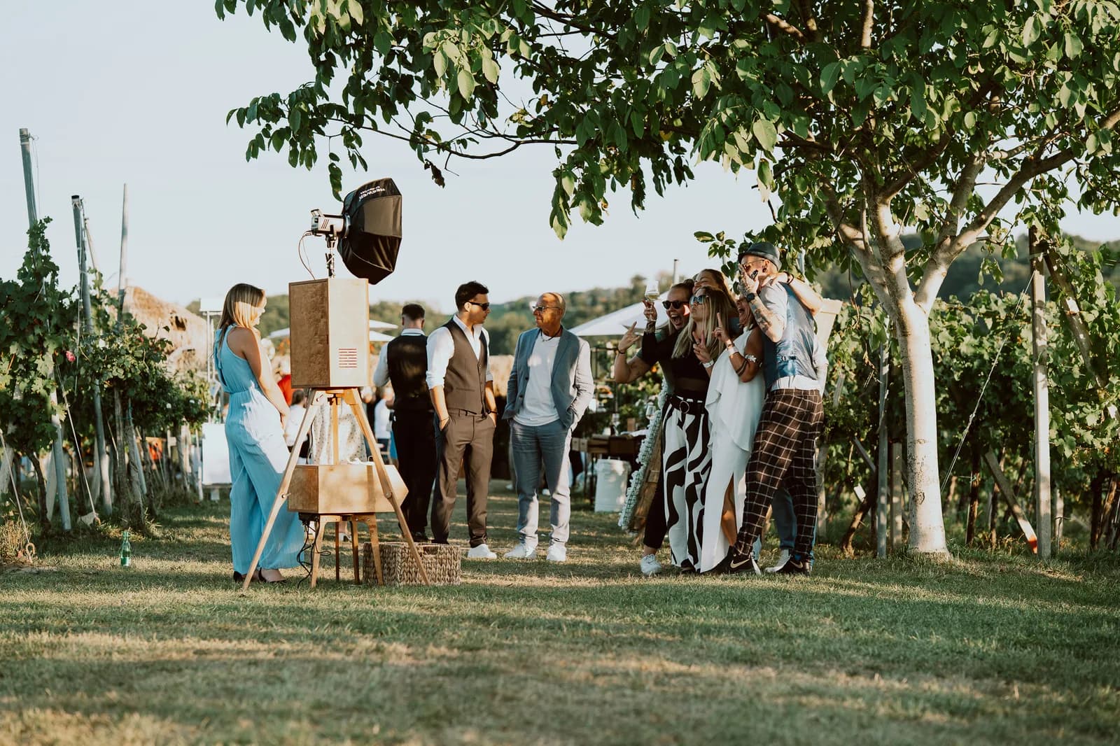 Gäste mit Fotografin vor der Fotobox bei einem Weingut-Event